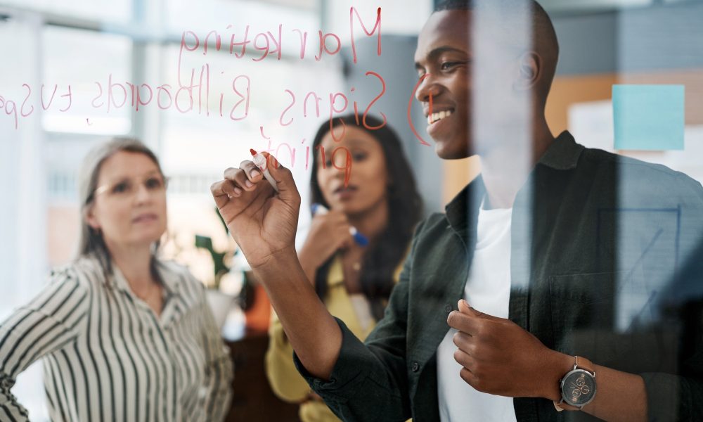 Shot of a group of businesspeople brainstorming in a modern office.